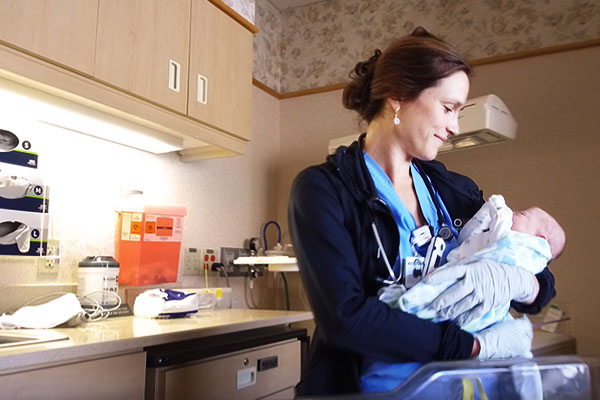 North Memorial Health nurse holding newborn