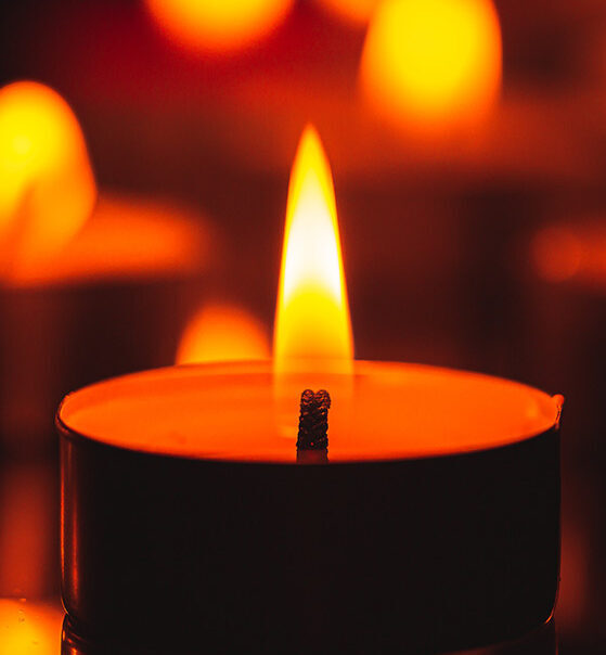 Flame-lit-round-candle-glowing-light-grief-and-loss-healing