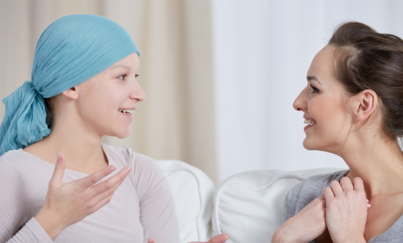 Young woman with cancer talking to friend