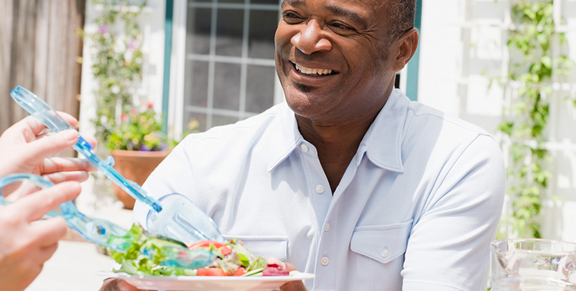smiling man with healthy salad