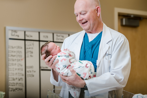 Maple Grove Hospital doctor holding baby