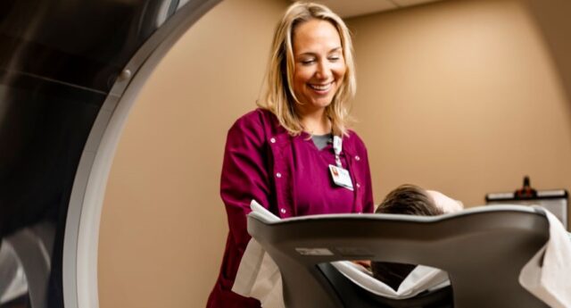 Maple Grove Hospital Tech near CT machine