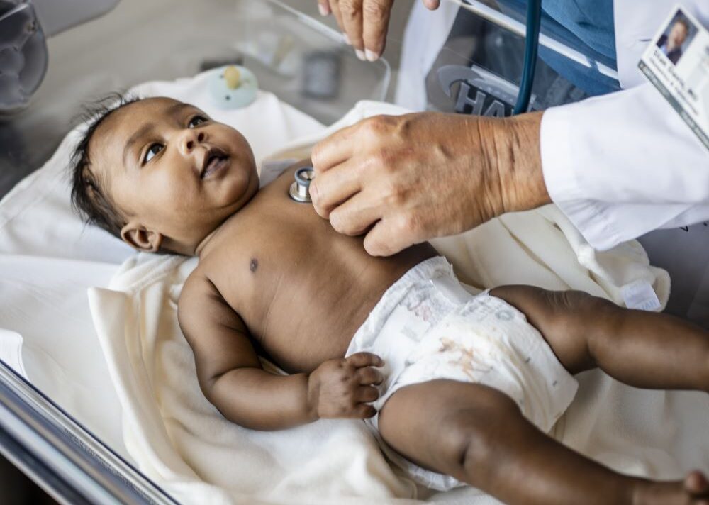 Hospitalist checking on newborn baby in hospital