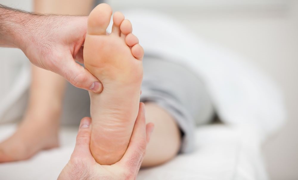 Doctor holding the foot of a woman