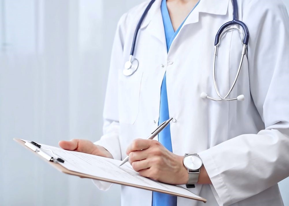 Healthcare professional doctor writing medical records on a clipboard