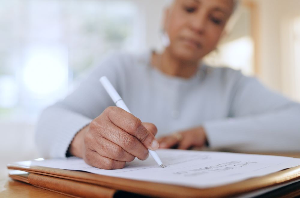Senior woman, sign and writing with documents