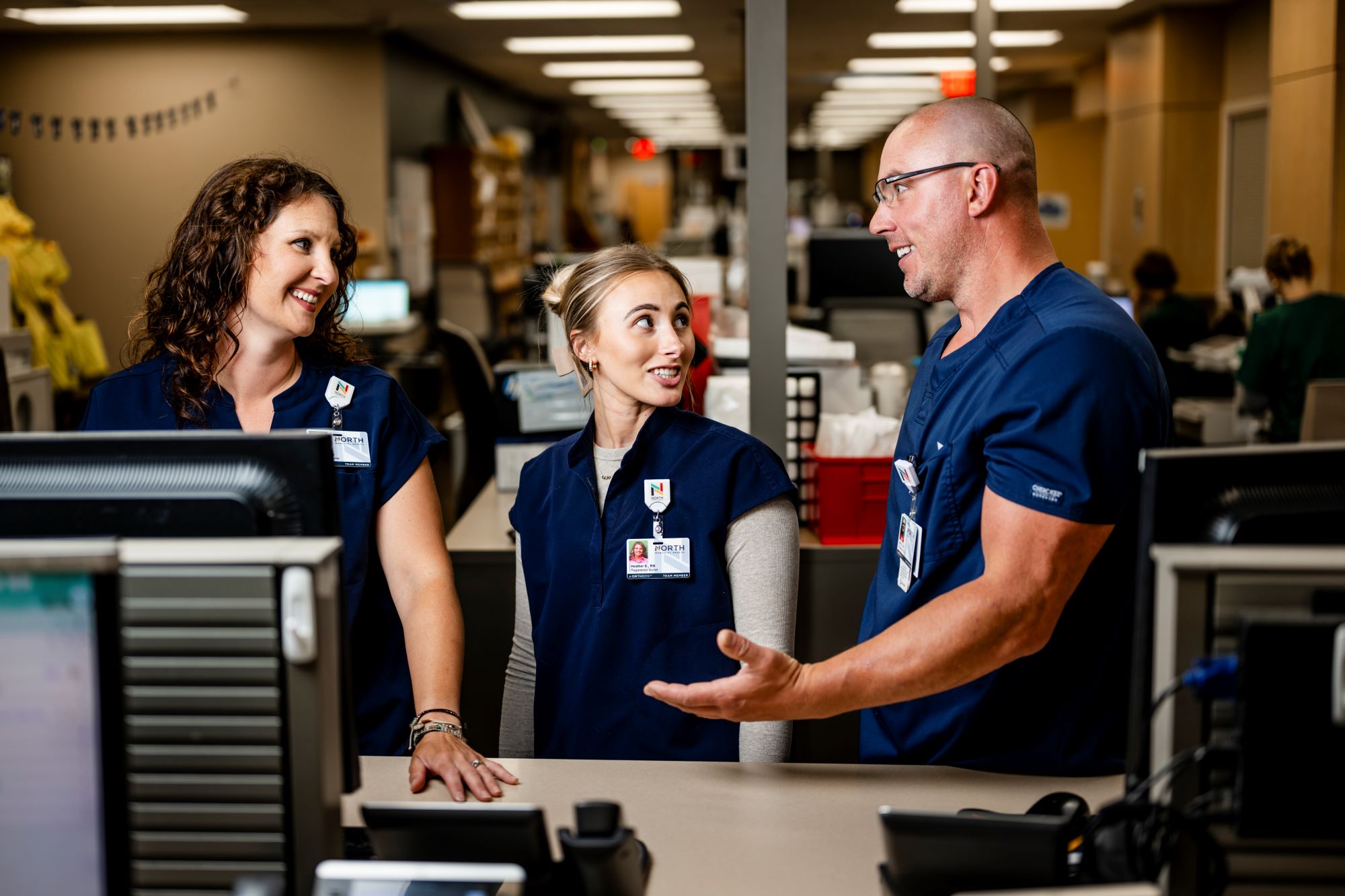Maple Grove Hospital Team Members Interacting at Desk