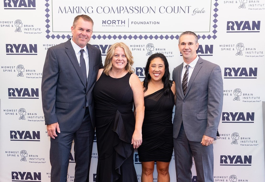 Four Gala attendees smiling for a photo at North Memorial Health Foundation's Making Compassion Count Gala