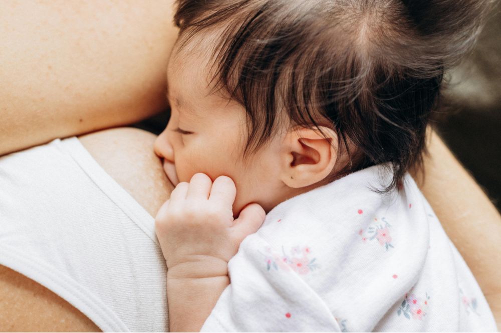 Mother breastfeeding her baby using the any latch method