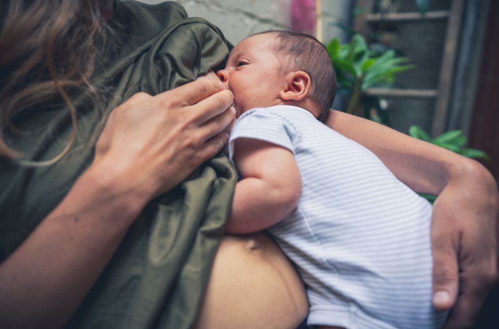 Mother breastfeeding her baby using the baby-led latch