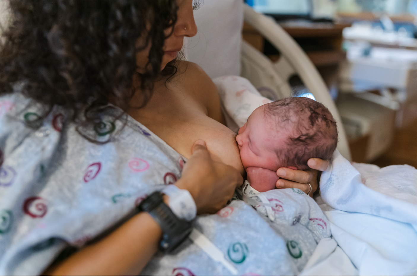 Mother breastfeeding her baby using the mother-led latch