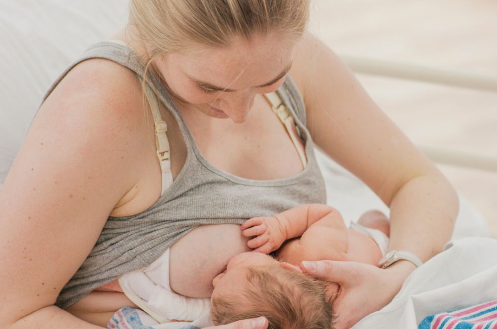 Mother breastfeeding her baby using the mother-led latch