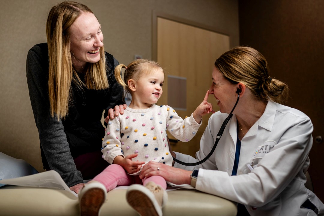 Pediatric doctor with child patient and parent